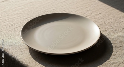 Elegant Minimalist Ceramic Plate on a Neutral Linen Surface with Soft Shadows.
