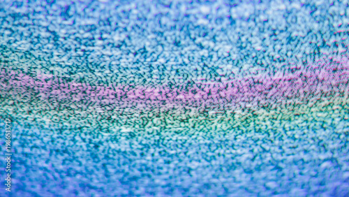 Crt tv static with a glowing pink horizontal band between blue teal and purple pixel noise