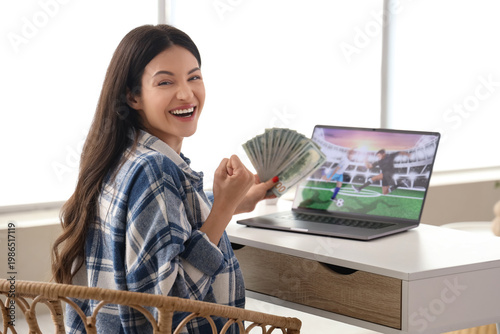 Happy young woman with mone...