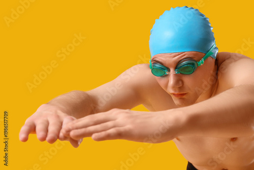 Male swimmer on yellow back...