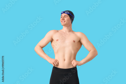 Male swimmer on blue backgr...