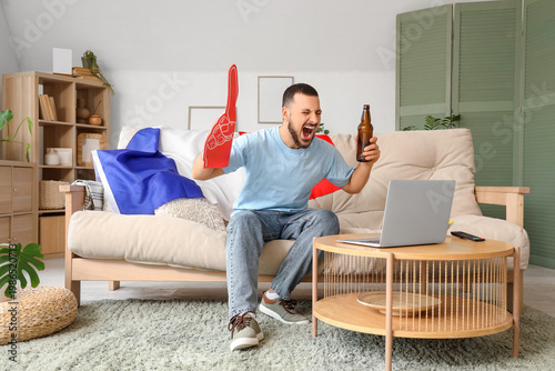 French sport fan with lapto...