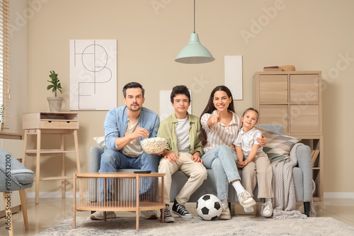 Happy family with popcorn a...