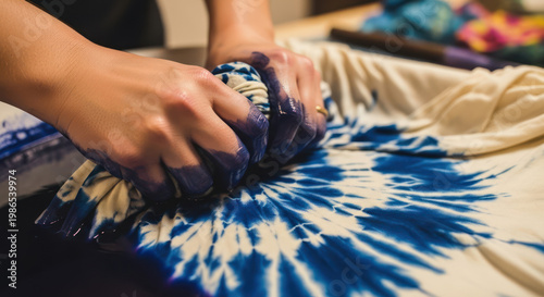 Hands Creating a Blue and White TieDye Pattern on Fabric.