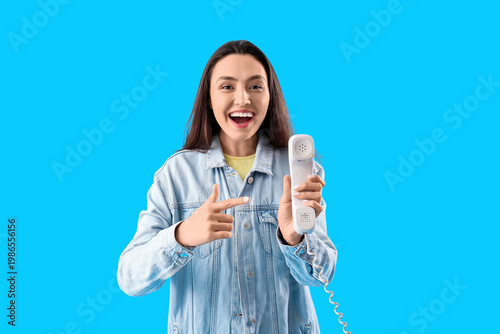 Happy young woman with tele...