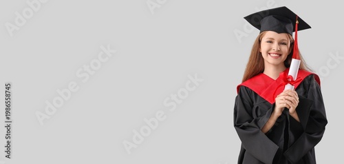 Tableau sur toile Female graduating student holding diploma on grey background with space for text