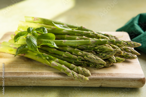 Asparagus preparation. Bunches of asparagus on a wooden board. Top view.
