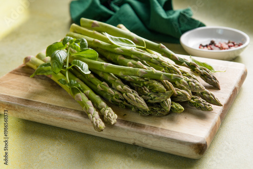 Asparagus preparation. Bunches of asparagus on a wooden board. Top view.