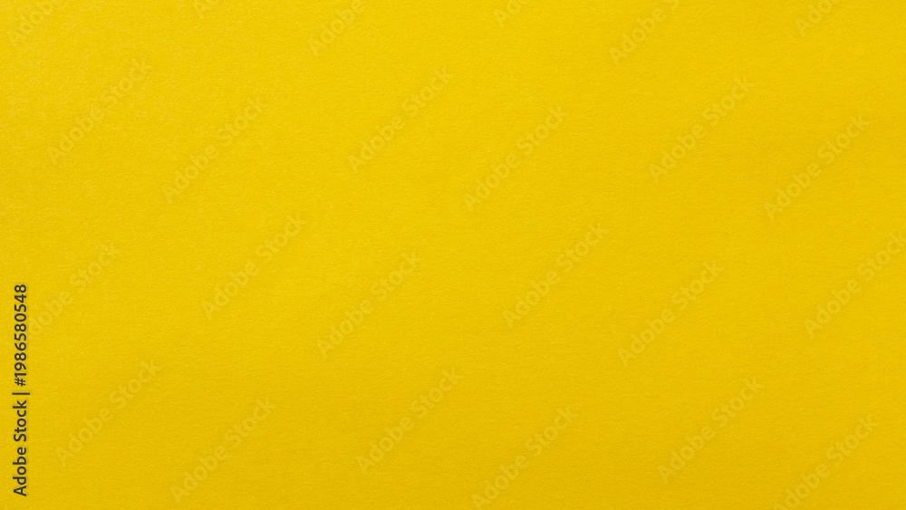 Fototapeta premium Bright yellow paper background surface with smooth uniform texture for copy space