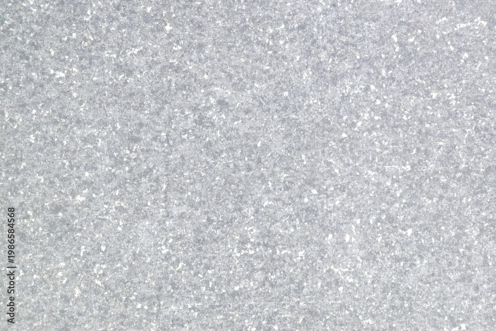Obraz premium Gray speckled stone texture background with a rough, natural appearance