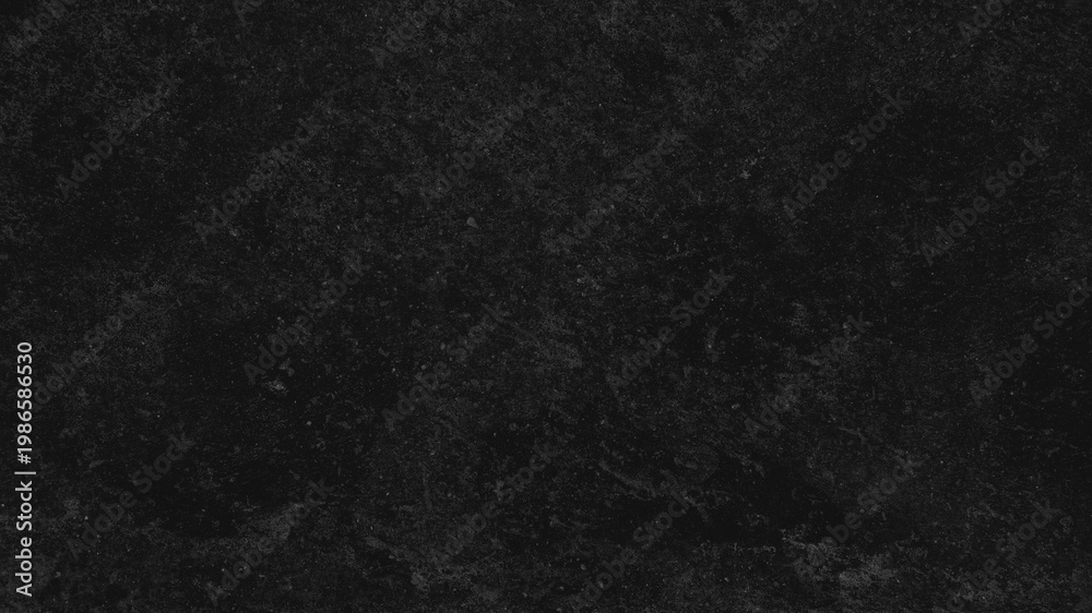 Fototapeta premium Dark textured desktop wallpaper with a rough, stone-like appearance in deep black tones