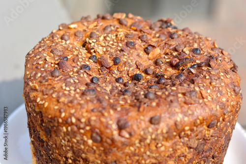 Traditional Easter cake decorated with chocolate chips, sesame seeds and sliced almonds.