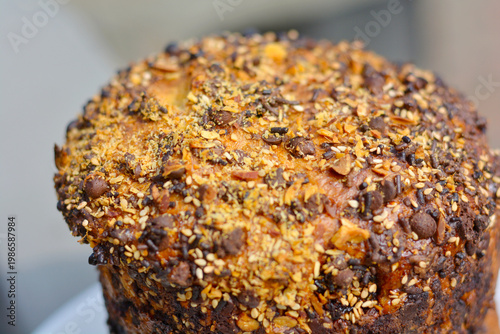 Traditional Easter cake decorated with chocolate chips, sesame seeds and sliced almonds.