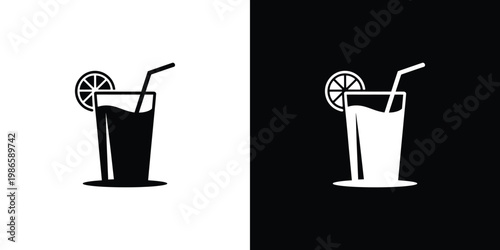 Black and white drink with lemon slices and straws