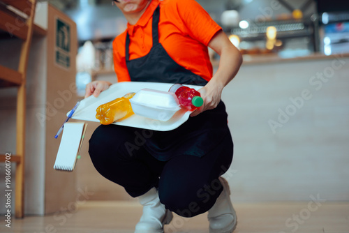 Clumsy Employee Drops Customer's Order Tray on the Floor. Restaurant worker spilling everything on the floor in the dining area
