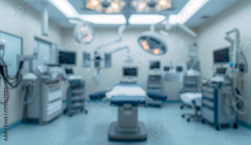 Blurred image of a modern operating room with sterile equipment, overhead surgical lights, monitors, and an empty surgical table, conveying a clinical atmosphere.