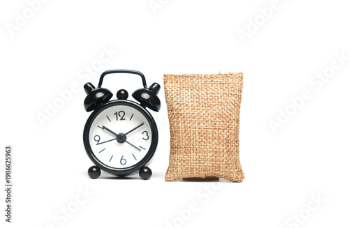 A picture of wheat bag with alarm clock on isolated white background. Harvesting time.