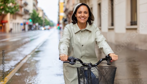 a woman is riding a bicycle with a big smile on the city road on a rainy day
