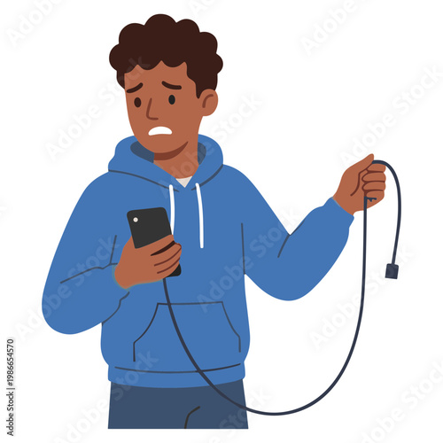Man looks frustrated while holding phone and broken charging cable.
