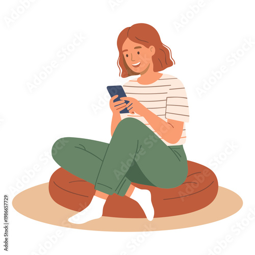 Woman sitting on bean bag chair using smartphone indoors relaxed