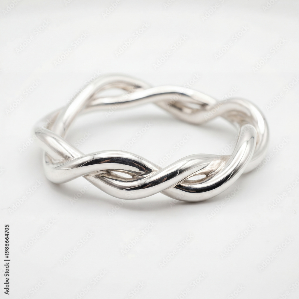 Fototapeta premium Twisted Silver Bangle on White Background with Sculptural Form for Elegant Jewelry Product Displays