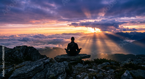 silhouette of a man in meditation in the mountains at sunrise.
