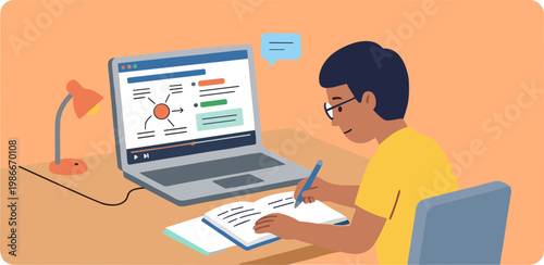 A person sits at a desk studying on a laptop with a notepad and lamp