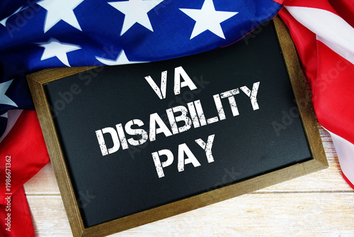 Obraz na plátně American flag with blackboard  VA Disability Pay on wooden background