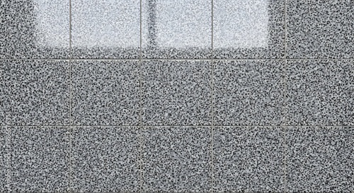 A dark grey asphalt and metal texture background showcases a rough stone surface pattern with closeup details of black rock and concrete material for a gritty street backdrop wallpaper design