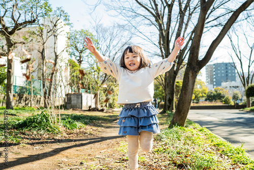 Close-up Portrait of a Happy Little Japanese Girl Outdoors in Winter