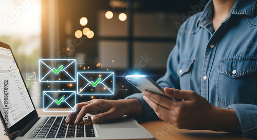 Person checking email notifications on laptop and smartphone with digital envelopes and checkmarks overlay