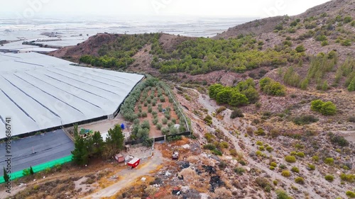 industry border greenhouse farming environment care protection nature invernaderos industrial roof building plastic sea dry forest - Andalusia, Spain - 2025