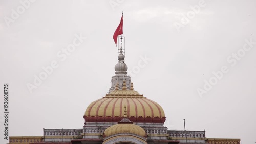 Close Up of Historic Hindu Temple Dome and Red Waving Flag