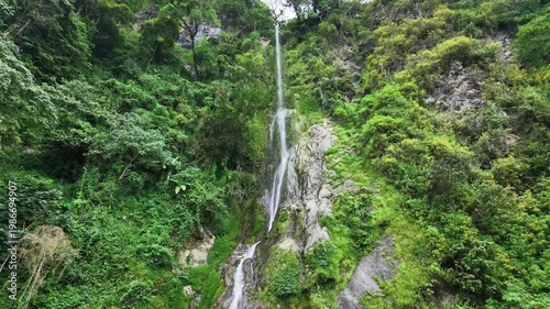 Majestic Tall Waterfall Flowing Down Steep Green Mountain Cliff