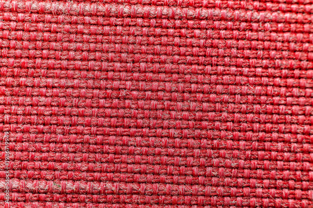 Fototapeta premium Macro photography of vibrant red woven fabric with detailed interlaced threads and symmetrical textile pattern for fashion industry background or upholstery material reference
