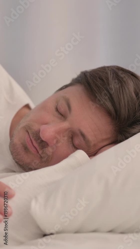 Adult Man Sleeping in Bed on Side, vertical