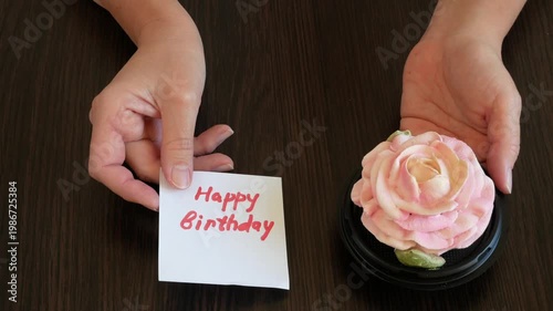 Zefir or marshmallows as pink rose and happy birthday card in hand, Gift box of Zefir, Zephyr and flowers.