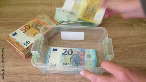 hand counting big stack of euro money on wooden background. money cash, closeup