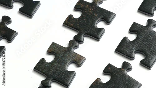 Big row of puzzles on white background, method for collecting puzzles by sorting