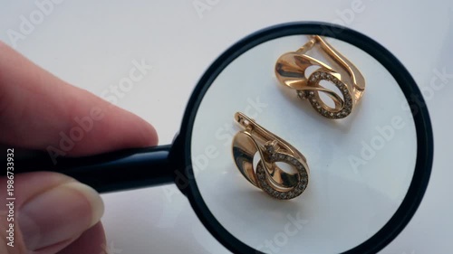 Pawnshop worker verify golden jewelry on many golden and silver jewelleries, scales and money background. Customers Buy and Sell Precious Metals, Jewels,