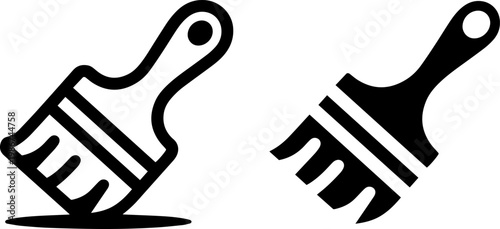 Two different types of paint brushes resting on a flat surface