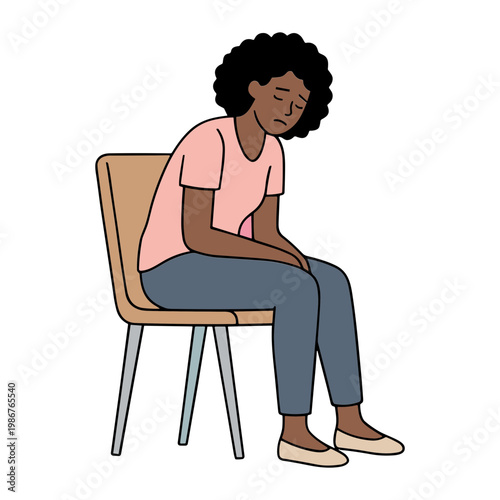 A woman sits on a chair looking down with an unhappy expression on her face.