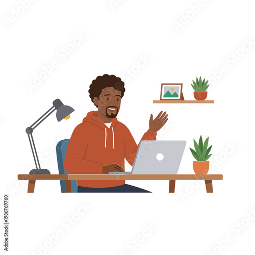 Man working on laptop with plants and lamp on desk indoors