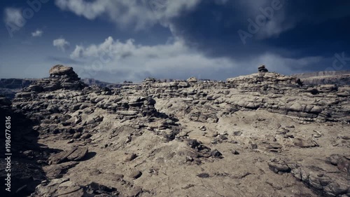 stratified rocky outcrop under blue clouds, exposed layers and textured sediment bands reveal geological history, ideal for sampling, drone mapping, erosion