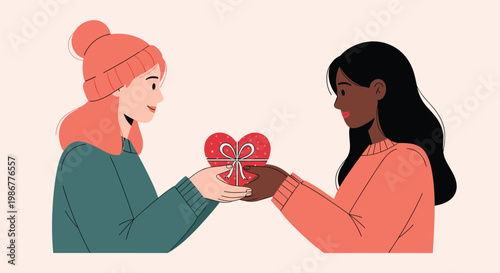 Two diverse young women exchanging a heart shaped gift box during a warm and friendly encounter in a simple setting.