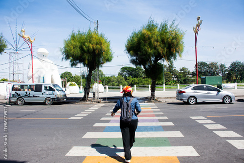 Landscape cityscape antique building and vintage retro architecture with thai people travelers walking crossing traffic road on zebra crosswalk at Rat Buri on November 21, 2025 in Ratchaburi, Thailand