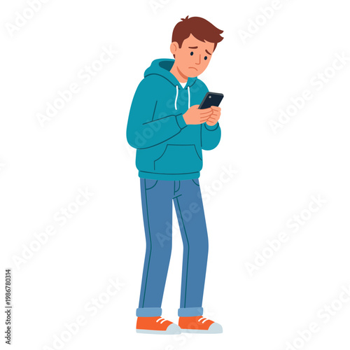 A young man stands looking at his phone with a concerned expression.