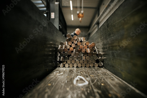 Cuadro en lienzo Steel round bars stacked in metal fabrication warehouse, raw material