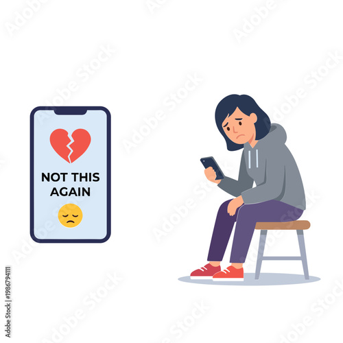 A young woman sits on a stool, looking at her phone with sadness