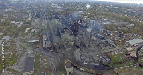 Aerial Close-up of Chimney Stacks Emitting Dark Smoke Plumes